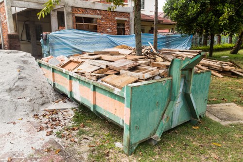 Construction site with waste clearance in progress in Leyton