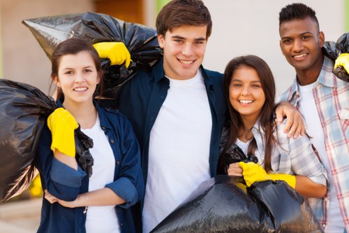 Workers performing a risk assessment next to skips