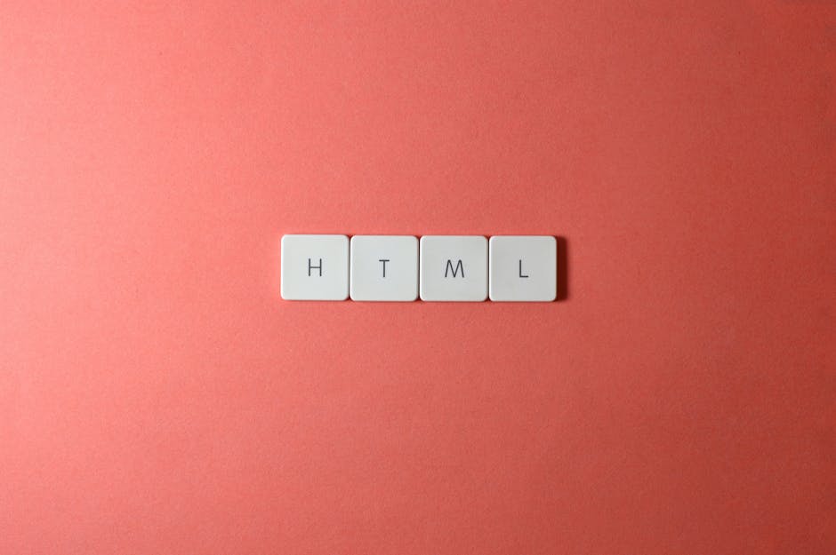 A close-up image of four white rectangular tiles with rounded edges, each featuring a black letter on the top surface that spell out 'H', 'T', 'M', and 'L' in a horizontal row. The tiles are arranged